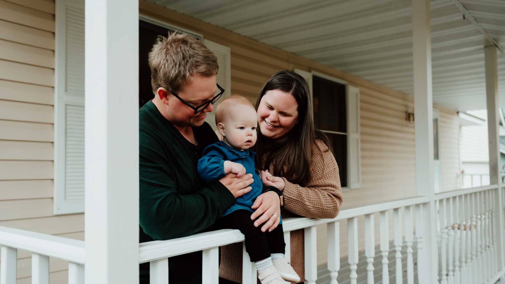 Family enjoying time together on a porch, highlighting the importance of home and community in Minnesota living costs.